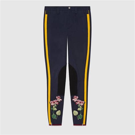 Shop the Flower embroidered legging with stripe by Gucci. An 